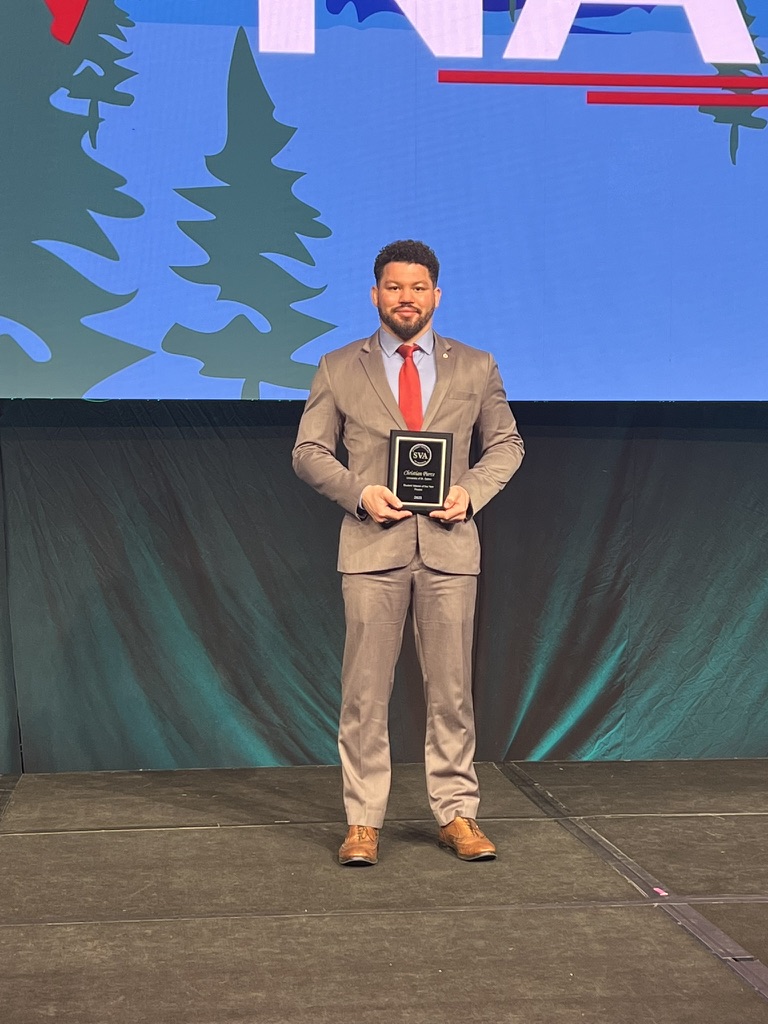 Christian Pierce on stage accepting an award from Student Veterans of America